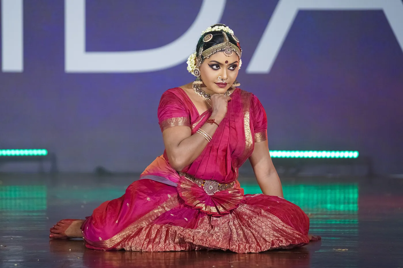 Shruthie Jayan Kalakshetra seated in a Bharatanatyam pose on stage